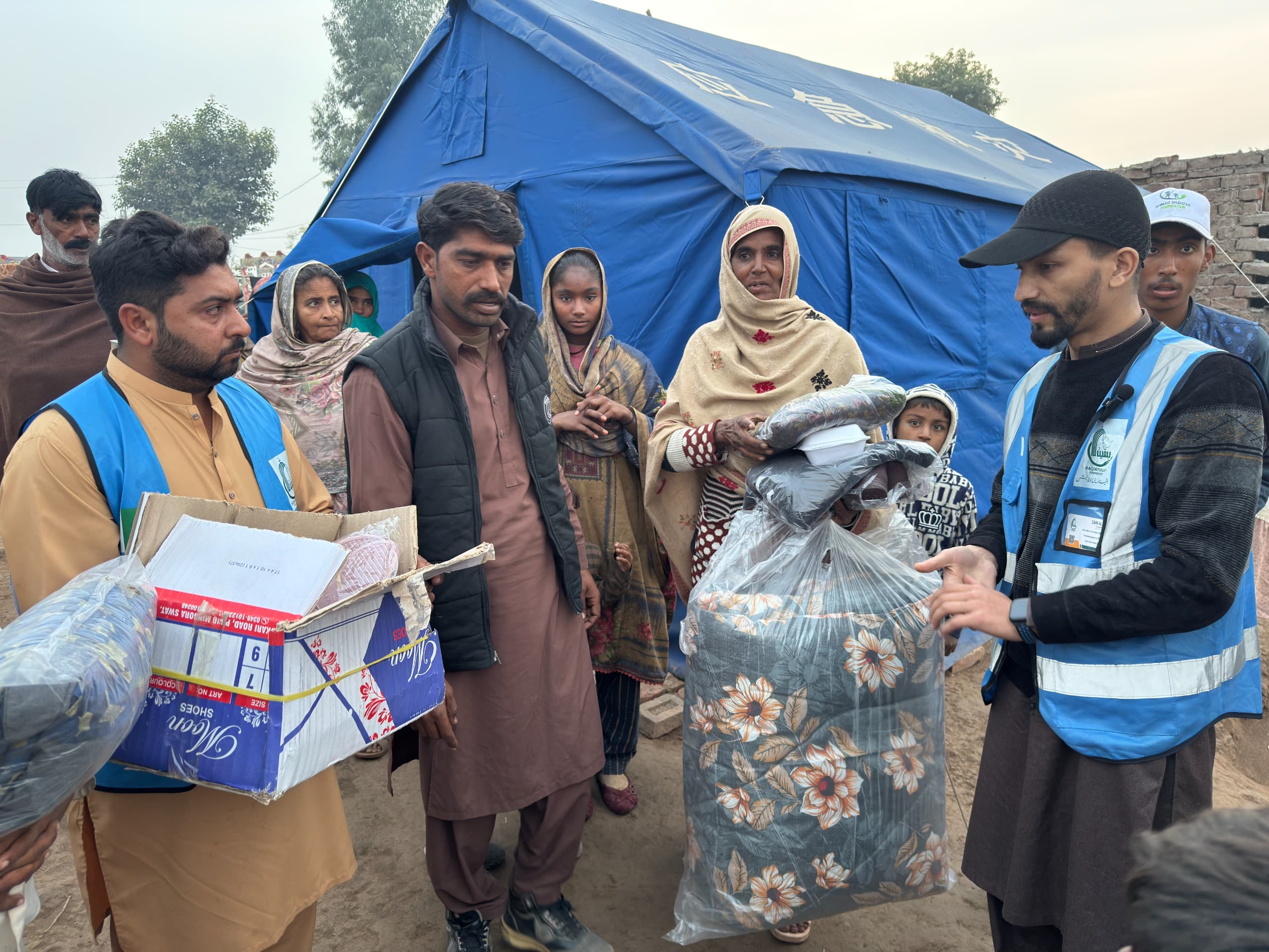 Baqiatullah Foundation relief workers distributing emergency aid to flood-affected families