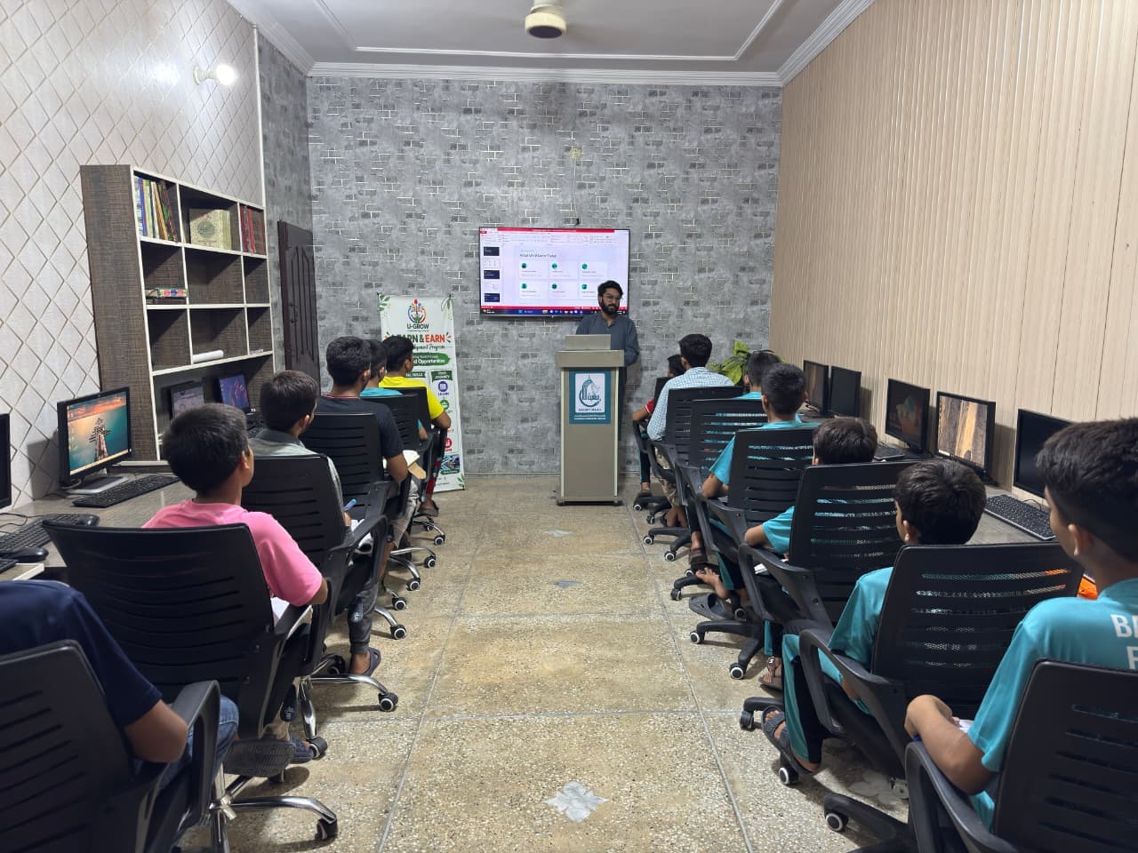 Students working at computers in the Baqiatullah Foundation digital education lab