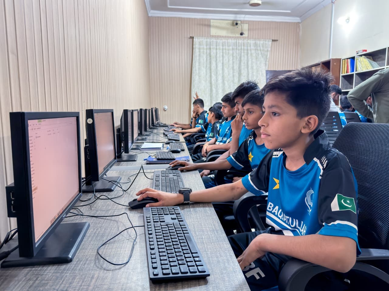 Students engaged in graphic design training at the foundation's digital lab