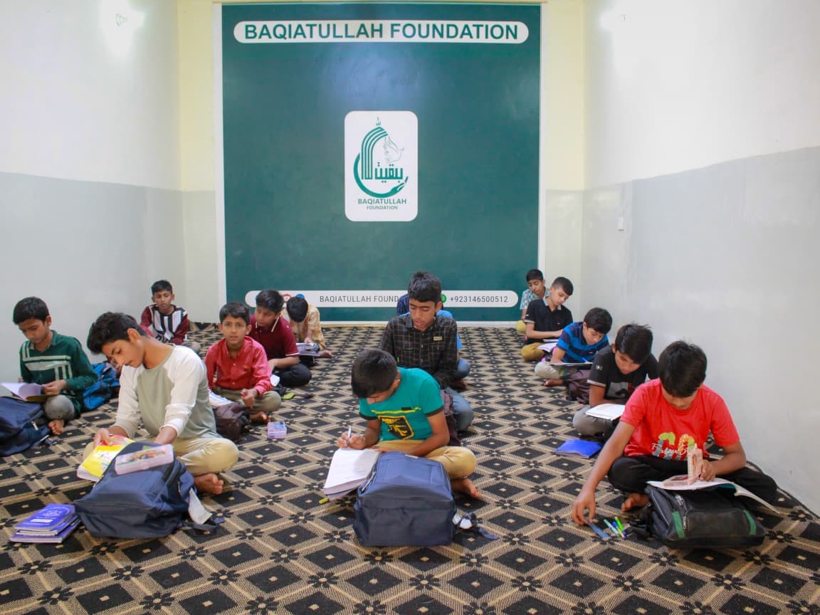 Children engaged in learning activities supported by Baqiatullah Foundation